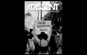 Cover of WeDissent journal featuring a woman with her back turned holding a sign that reads: We are no longer afraid of them.